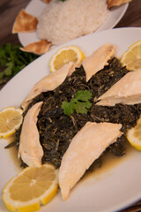 Lebanese recipe Mouloukhia , Melokhiyah, corete leaf and coriander rice chicken, grilled pita. High quality photo