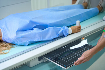 Adult woman being prepared for diagnostic radiography in clinic