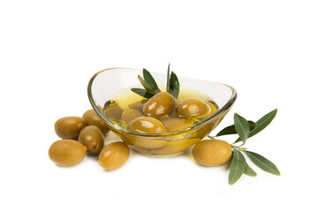 Bowl of fresh olive oil and olives with leaves isolated on white background. Delicious olive oil in a glass bowl. olive oil bottle.