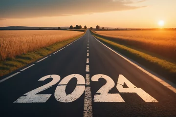 Fotobehang View of a landscape with a road running through it in the center reaching to the horizon. The writing 2024 on the asphalt - New Year and business concept © Giuseppe Cammino