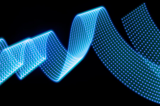Blue neon curved wave of light as curls or swirl with dotted stripes on black background. Abstract background with motion light effect, light painting in contemporary style.