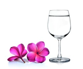 Glass of water and frangipani flower isolated white background