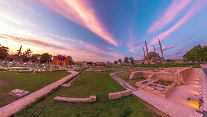 Edirne, Turkey evening with stunning cityscape. Eski Ulu Old Mosque and Selimiye Mosqueare in sunset golden hues, framed by graceful presence of Architect Sinan statue and Edirne Municipality building