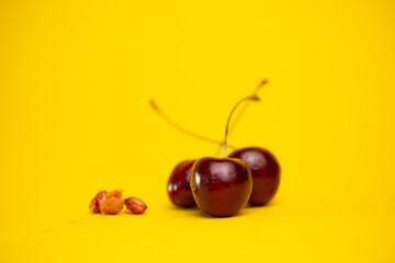 ripe fresh cherry berries on a yellow background