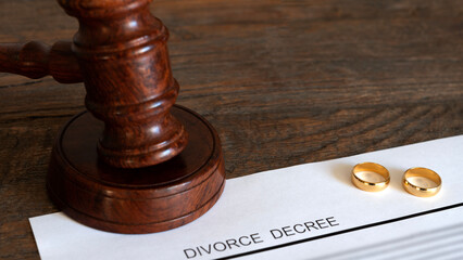 gavel and wedding rings on wooden table
