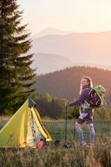 Woman hiker camping in mountains. Attractive, young woman hiking outdoors in summer. Sporty, slim...