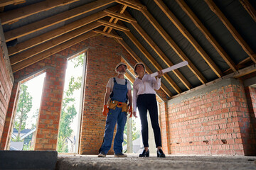 Construction superintendent and builder conducting inspection of house