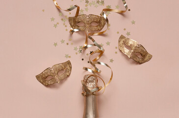 Festive background with Champagne bottle, carnival masks, streamers serpentine and golden glitter...