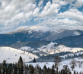 Small alpine village and winter snowy mountains, Voronenko, Carpathian, Ukraine.