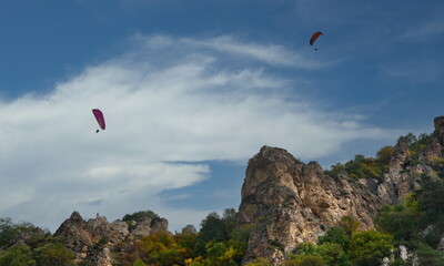 Russia. North Caucasus, Kabardino-Balkaria. Paragliding flight over the picturesque cliffs of the Chegem gorge.