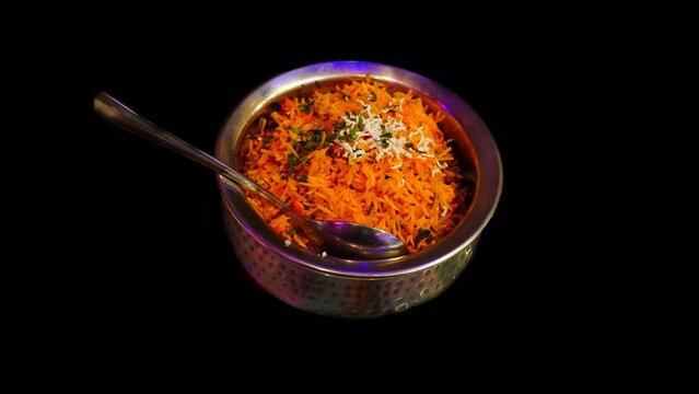 veg biryani on aluminium bowl with black background