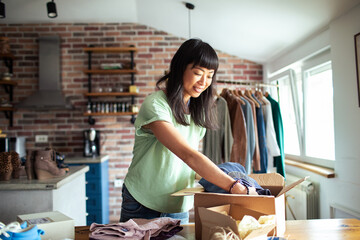 Young woman working in online store office packing shipment