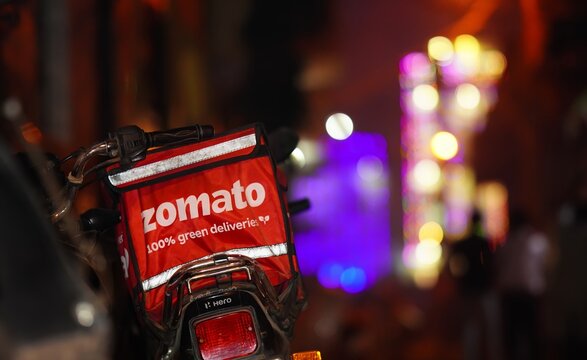 zomato food delivery during fastival a food delivery red bag on bike at night paschim vihar, Delhi, India- 11 Nov 2023