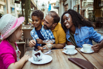 Multicultural Family Enjoying Desserts at an Outdoor Cafe