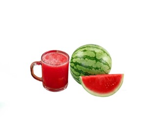 The white background in the picture is red watermelon juice in a clear glass and a fresh red watermelon cut in half next to each other.