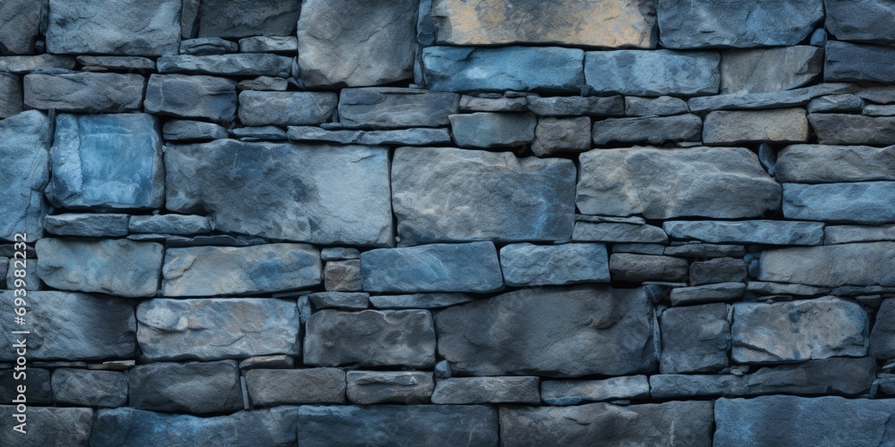 Poster a picture of a blue stone wall with a fire hydrant in front of it. this image can be used to represe