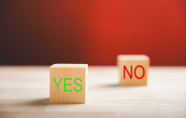 Decision-making concept portrayed by wooden block's green check mark and red x. Choice symbolism...