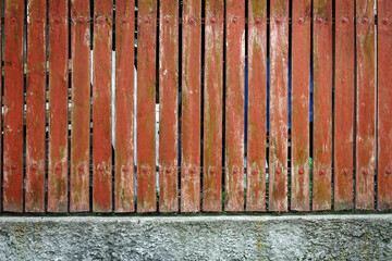 Fence of red wooden boards
