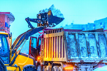 Snow clearing of utility services  on city streets in winter after a snowstorm or snowfall. Snow...