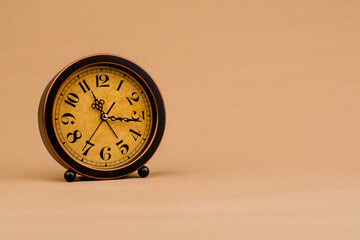 Brown vintage alarm clock Photo of a stationary clock, concept of time and how time works.