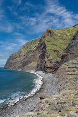 Fototapeta na wymiar Porto Moniz, Madeira, Portugal – July 29 2023: Dramatic seascape with rugged cliffs and the blue Atlantic Ocean, Achadas da Cruz on the island of Madeira.