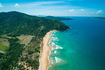 Aerial view of tropical sandy beach in bay with blue water. Seascape with sea, sand, palm trees....