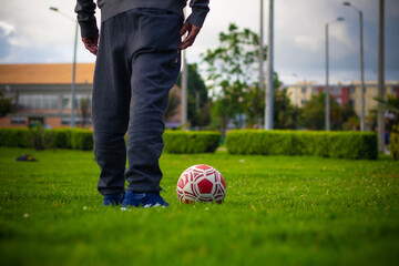 pensioner senior man with a soccer ball in a park
