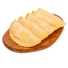 Frozen homemade cheburek on a wooden board on a white background, isolated