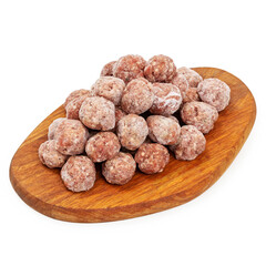 Homemade frozen meatballs on a wooden board on a white background, isolated