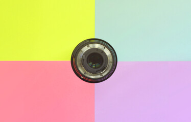 Minimalism with photographic lens on blue, violet, pink and yellow background. Trendy pastel...