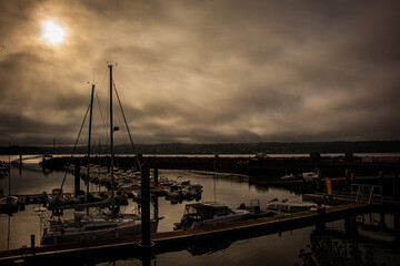 Fototapeta premium Brest marina with overcast sky clouds sunrise with orange, gold, golden, red sky