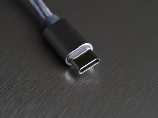 USB Type-C cable on a dark background, close-up, selective focus