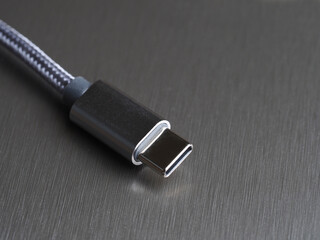 USB Type-C cable on a dark background, close-up, selective focus