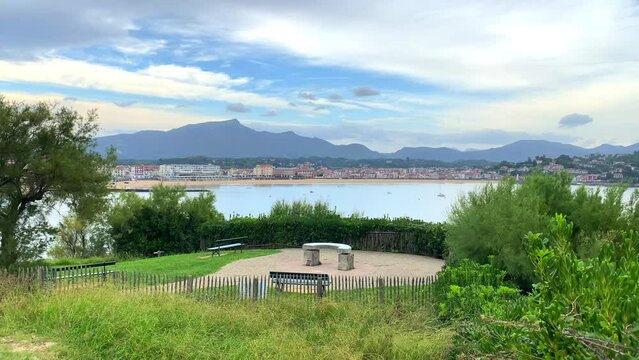 Benches and orientation table on Sainte-Barbe hill and seaside of Saint-Jean-de-Luz on the background in France