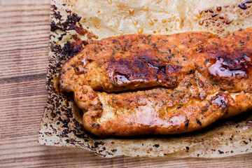 fried chicken fillet in parchment with spices and herbs