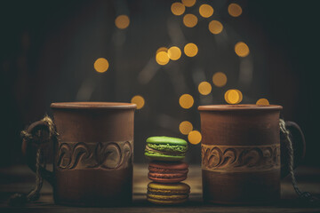 Macarons of different colors and coffee with a beautiful background and blur, treats for loved ones