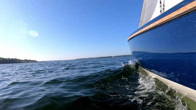 Low angle shot of a sailing boat sailing on choppy sea on the Baltic Sea