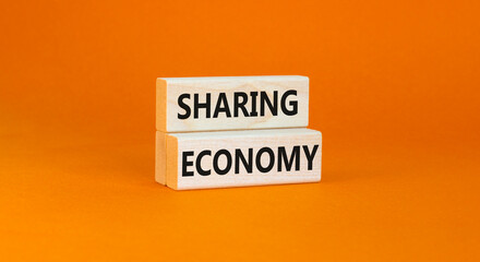 Sharing economy symbol. Concept words Sharing economy on beautiful wooden blocks. Beautiful orange table orange background. Business sharing economy concept. Copy space.