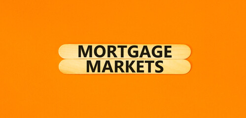 Mortgage markets symbol. Concept words Mortgage markets on beautiful wooden stick. Beautiful orange...