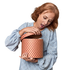 Middle-aged woman excitedly opening Valentine's box