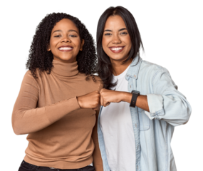 Young Latina friends celebrating with a fist bump