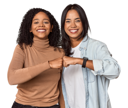 Young Latina friends celebrating with a fist bump - Powered by Adobe