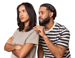 Young Latin man apologizing, couple back-to-back, studio