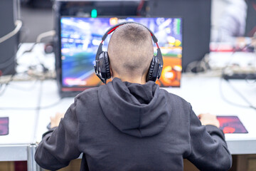 Young gamer playing online computer video game. Video game addiction concept.