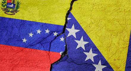 Venezuela and Bosnia and Herzegovina flags on a stone wall with a crack, illustration of the concept of a global crisis in political and economic relations