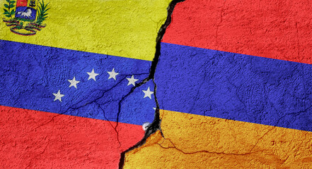 Venezuela and Armenia flags on a stone wall with a crack, illustration of the concept of a global crisis in political and economic relations