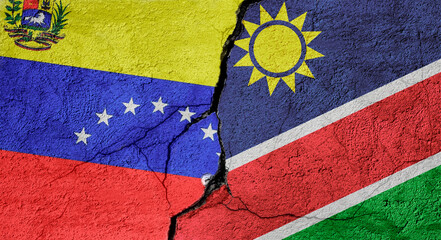 Fototapeta premium Venezuela and Namibia flags on a stone wall with a crack, illustration of the concept of a global crisis in political and economic relations