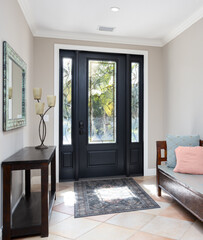 Bright vacation rental foyer with stained glass and bench
