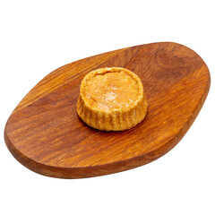 Soft cheese baked on a wooden board on a white background, isolated