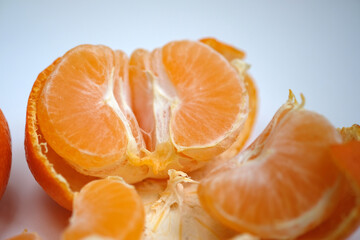 peeled tangerine on light background
